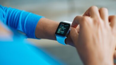 person in blue long sleeve shirt using smart watch